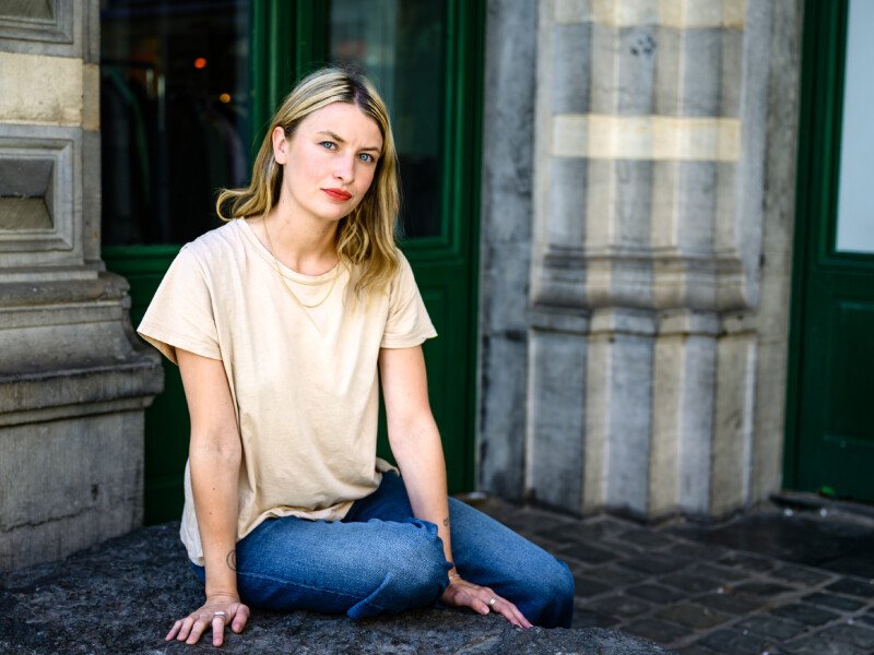 Colette Goossens zit neer op stenen bankje